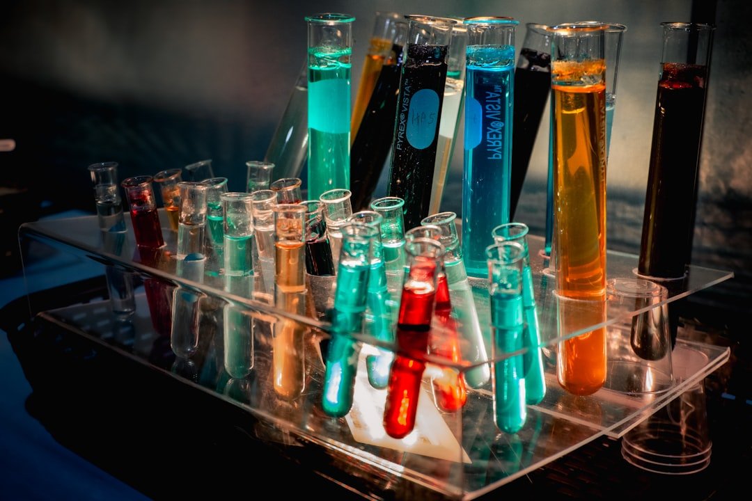 a-bunch-of-test-tubes-filled-with-different-colored-liquids-lulun7f32c